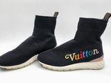 a pair of black sneakers with the word vuitton written on them
