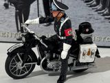 a figurine of a man in uniform on a motorcycle