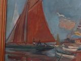 a painting of a sailboat on display in a wooden frame