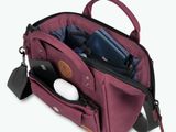 a purple bag with a cell phone and other items in it
