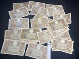 many different types of currency are laid out on a black surface