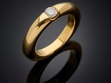 a gold ring with a single diamond on top