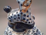a figurine of a giraffe on a blue and white plate