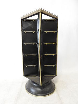 a black and gold display case on a pedestal