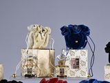 a lot of small bags of perfumes on a table