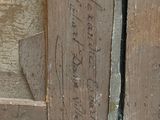 a close up of a wooden door with writing on it