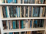 a book shelf with many books on it in a room