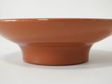 a brown bowl sitting on top of a white table