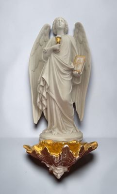 an image of a statue of an angel holding a book