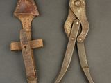 pair of old metal pliers with wooden handles on a gray surface