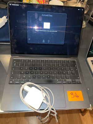 a laptop computer sitting on top of a desk with a charger