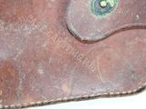 a brown leather wallet sitting on top of a white table