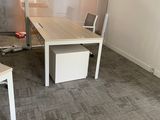 an image of a conference room with a desk and chairs