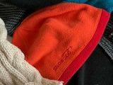 a pile of clothing that includes a hat, scarf, and other items