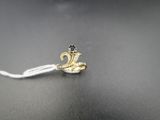 a small gold snake on a white cord