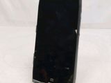 a black cell phone sitting on top of a table