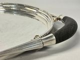 a silver plate with a black handle and a black handle