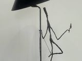 a black lamp with a black shade on top of it