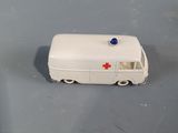 a white toy ambulance with a red cross on it