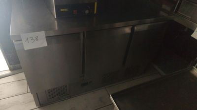 a stainless steel refrigerator with a sign on the door