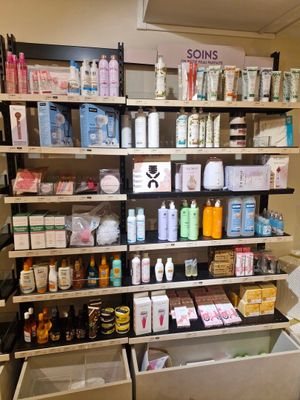 a lot of bottles and containers on the shelves in the store