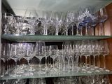many wine glasses on the shelves in the room