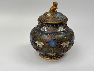 a vase with a lid that has a bird on it