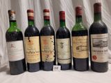 several bottles of wine are lined up on a table