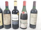 several bottles of wine are lined up on a white surface