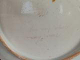 a white plate with writing on it sitting on a table