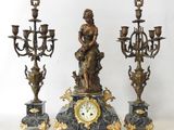 a statue of a woman sitting on top of a clock
