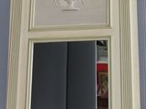 a mirror that is sitting on a shelf in a room