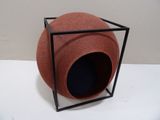 a red ball sitting inside of a black box