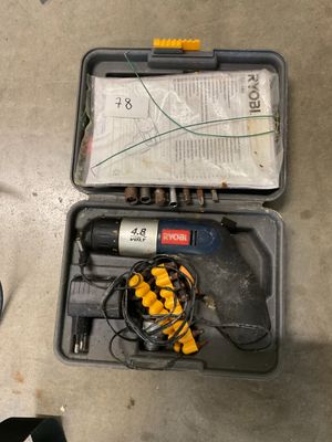 a tool in a case on the floor next to a pair of shoes