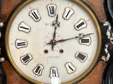 a close up of a clock with roman numerals on it
