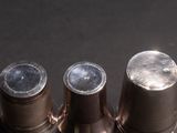 three silver cups sitting on top of a black table