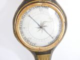 a gold and black watch with a compass on it