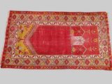 a red rug with a yellow and red design on it