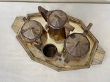 a gold tray with a tea set on it