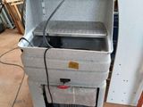 a cooler that is sitting in the middle of the floor