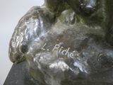 a bronze statue of a child holding a teddy bear