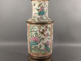 an image of a vase with a bird on it on a stand