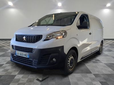 the white van is parked in a large room with a checkered floor