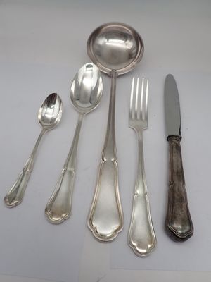 a lot of silver spoons and spoons on a table