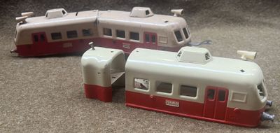two toy trains sitting on the floor next to each other