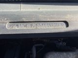a close up of a car ' s engine cover with a sticker on it