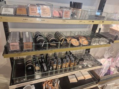 a lot of makeup products on the shelves in the store