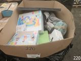 a cardboard box filled with books and other items
