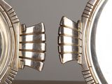 two silver fish shaped objects on a table