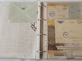 an open book with a lot of papers and stamps on it